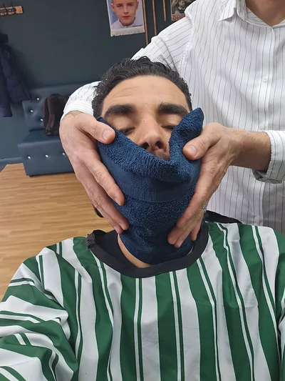 Client receiving a hot towel shave