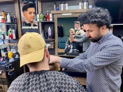 Boy receiving a haircut at Class Barber